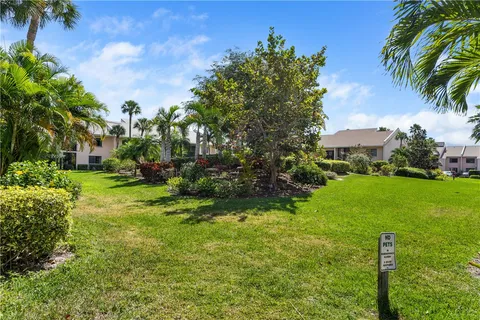a view of a garden with a building in the background