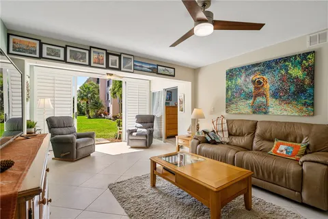 a living room with furniture a rug and a large window