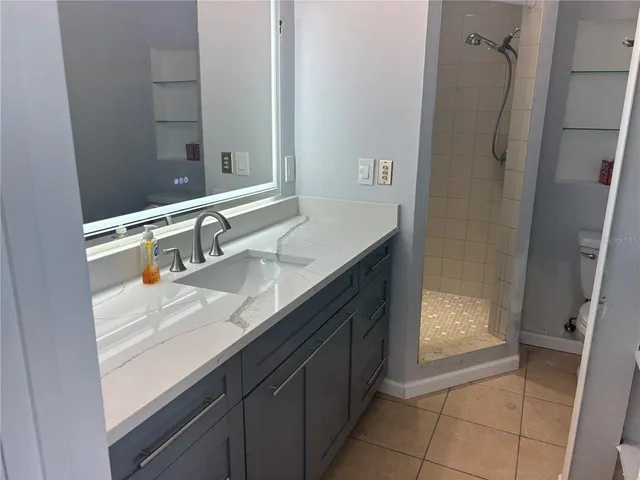 a bathroom with a glass shower door