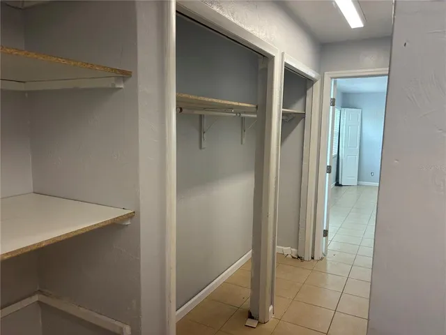 a view of a yard with wooden fence