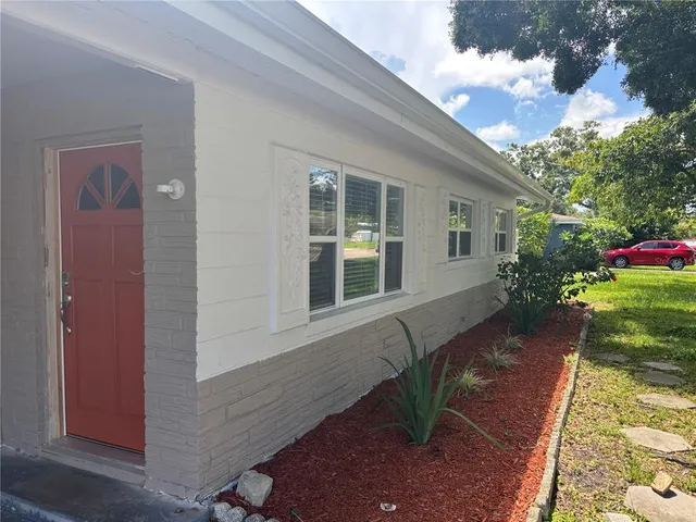 a view of house with backyard