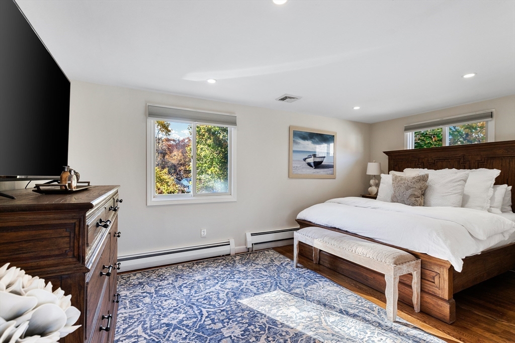 4 Senator Road Woburn, MA 01801 - Photo 11 of 36 a bedroom with a bed and a flat screen tv