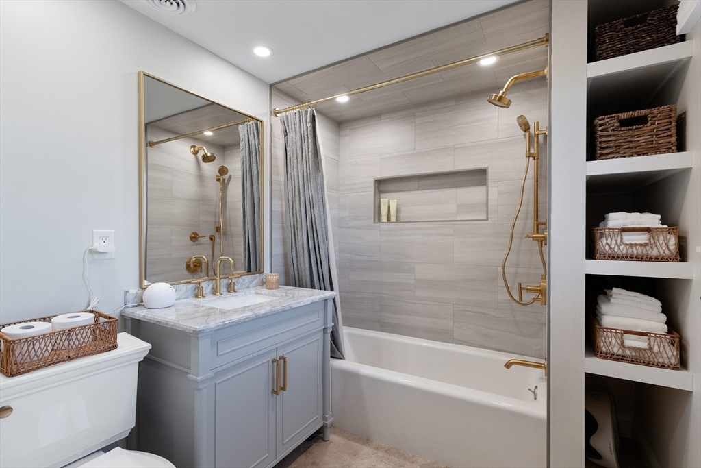 4 Senator Road Woburn, MA 01801 - Photo 13 of 36 a bathroom with a granite countertop sink a toilet and shower
