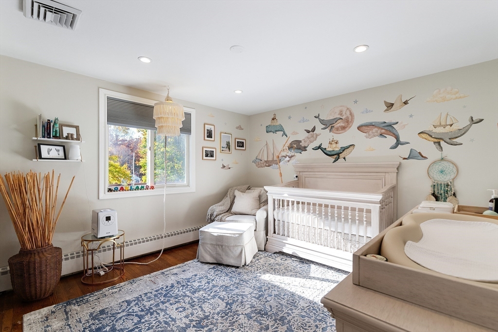 4 Senator Road Woburn, MA 01801 - Photo 14 of 36 a living room with furniture and a baby crib