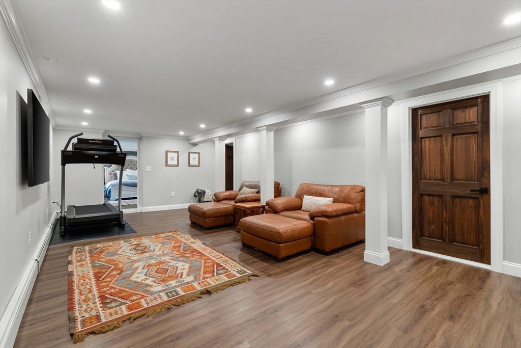 4 Senator Road Woburn, MA 01801 - Photo 17 of 36 a living room with furniture and a wooden floor