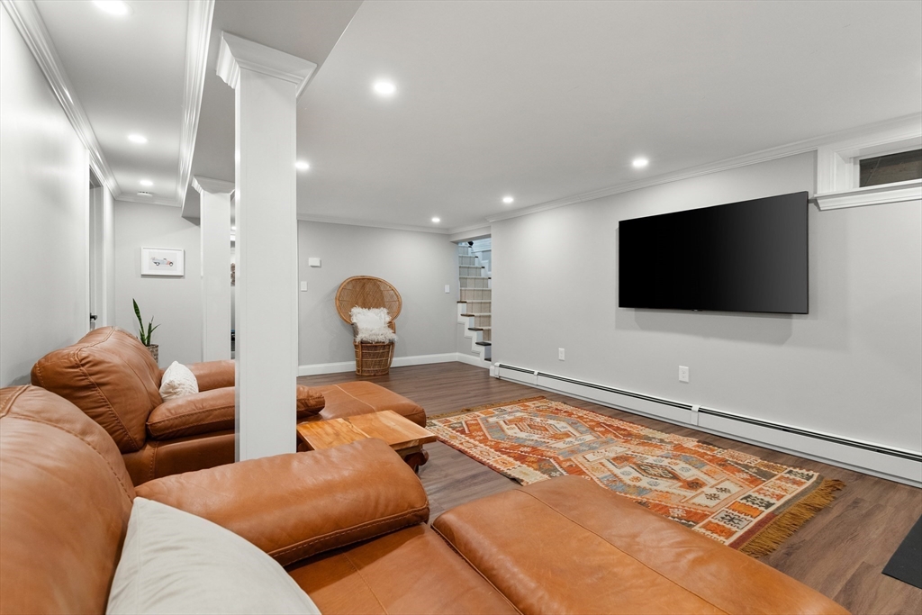 4 Senator Road Woburn, MA 01801 - Photo 18 of 36 a living room with furniture and a flat screen tv