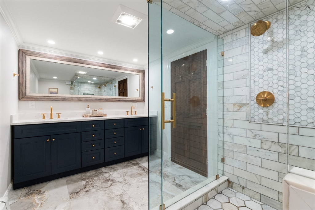 4 Senator Road Woburn, MA 01801 - Photo 22 of 36 a bathroom with a granite countertop sink a mirror and shower
