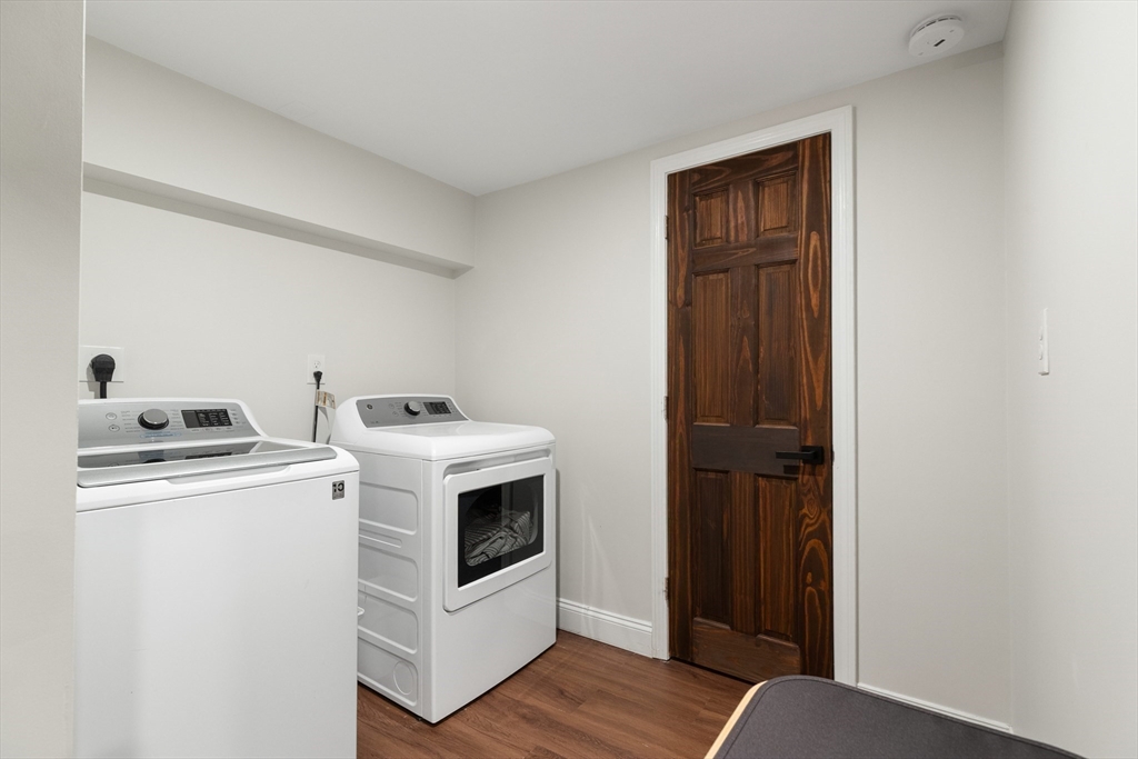 4 Senator Road Woburn, MA 01801 - Photo 24 of 36 a view of washer and dryer with wooden floor