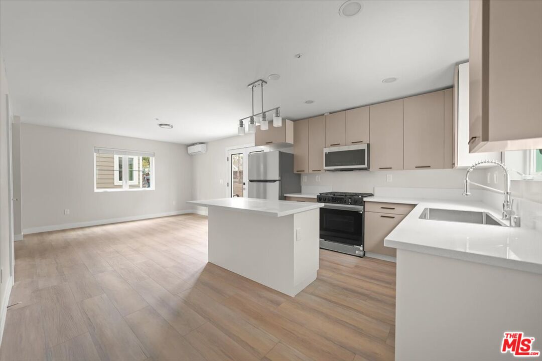 1317 Punta Gorda Street, Unit 10 Santa Barbara, CA 93103 - Photo 11 of 70 a kitchen with granite countertop a stove top oven a sink dishwasher and a oven with wooden floor