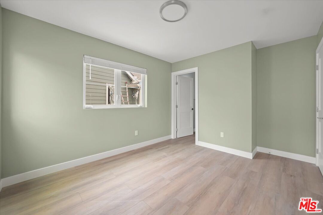 1317 Punta Gorda Street, Unit 10 Santa Barbara, CA 93103 - Photo 15 of 70 an empty room with wooden floor and windows