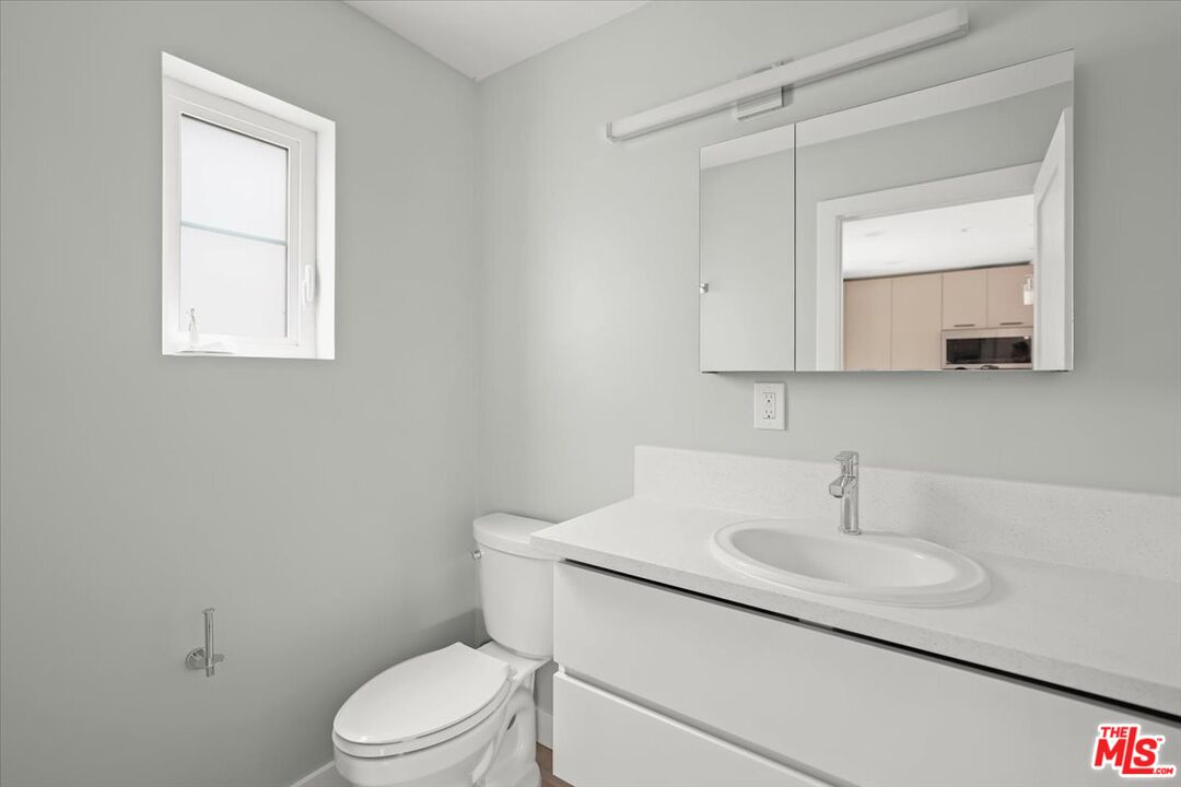 1317 Punta Gorda Street, Unit 10 Santa Barbara, CA 93103 - Photo 26 of 70 a bathroom with a sink a toilet and mirror