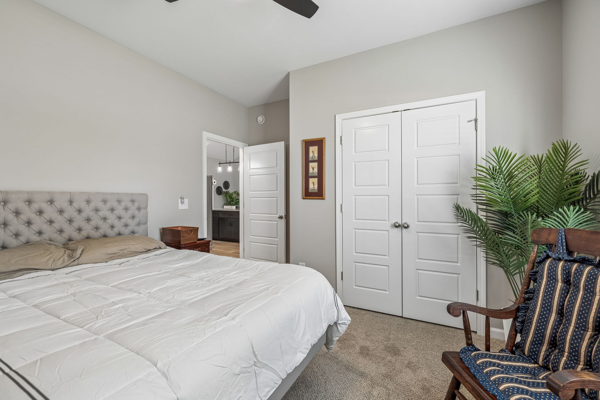 180 Vickers Hill Road Smithville, TN 37166 - Photo 23 of 33 a bedroom with a large bed and a potted plant