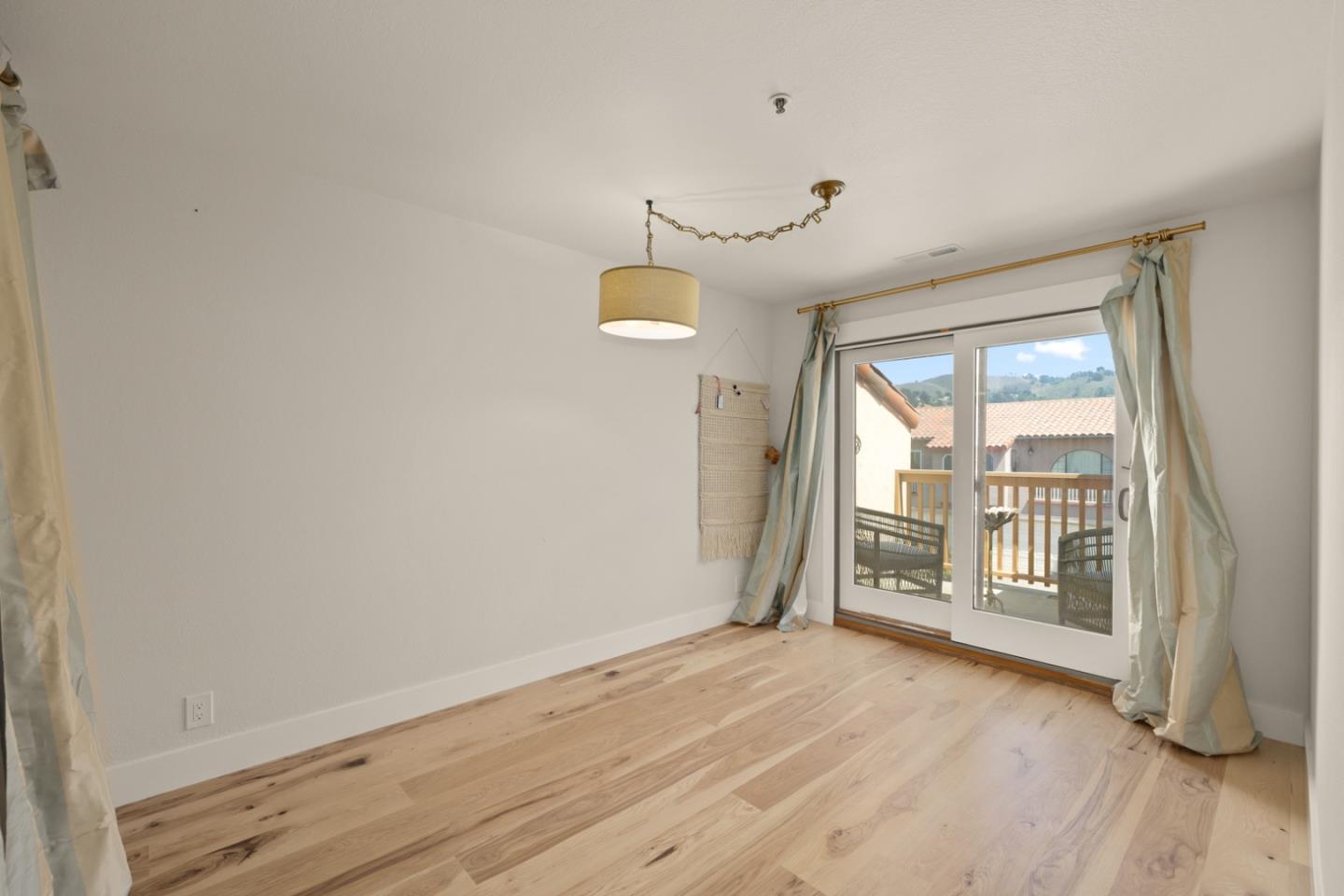 2346 Beach Boulevard Pacifica, CA 94044 - Photo 14 of 22 an empty room with wooden floor and windows