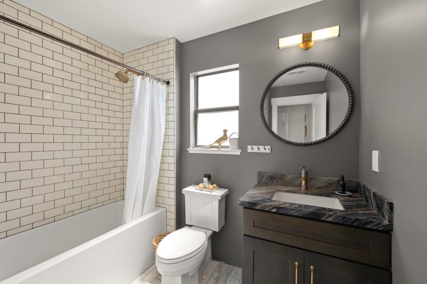 2346 Beach Boulevard Pacifica, CA 94044 - Photo 15 of 22 a bathroom with a granite countertop toilet a sink a mirror a vanity and shower