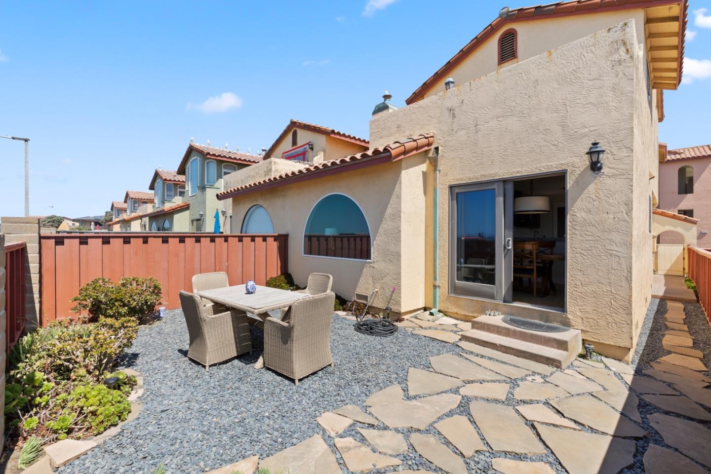 2346 Beach Boulevard Pacifica, CA 94044 - Photo 16 of 22 a view of a patio with table and chairs and potted plants
