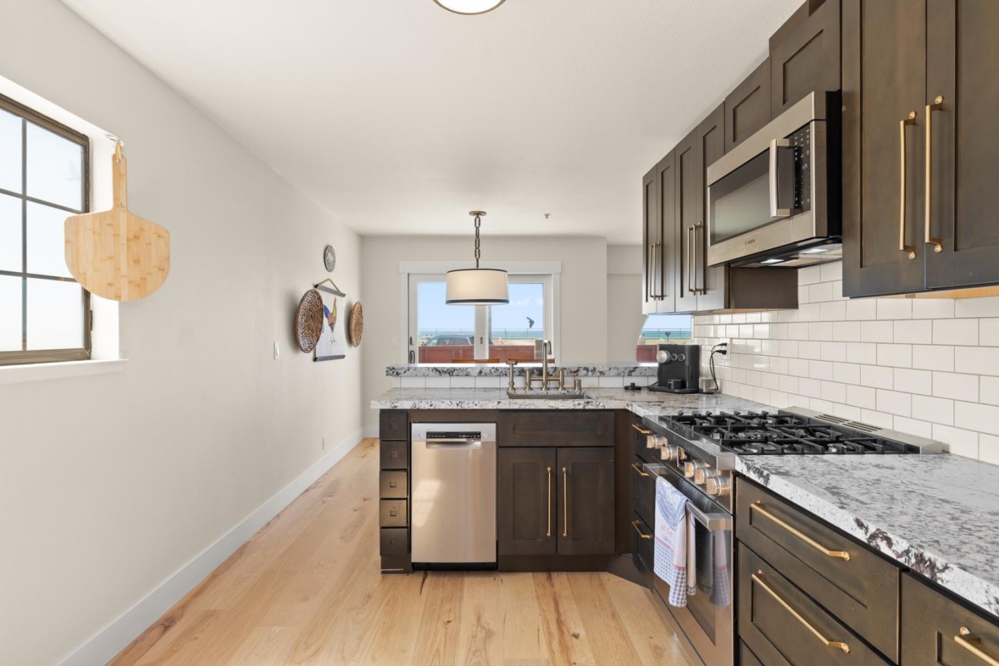 2346 Beach Boulevard Pacifica, CA 94044 - Photo 6 of 22 a kitchen with stainless steel appliances granite countertop a stove and a sink