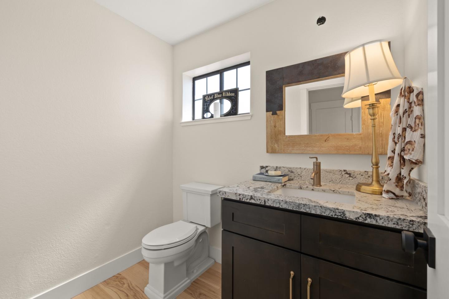 2346 Beach Boulevard Pacifica, CA 94044 - Photo 9 of 22 a bathroom with a granite countertop sink toilet and mirror