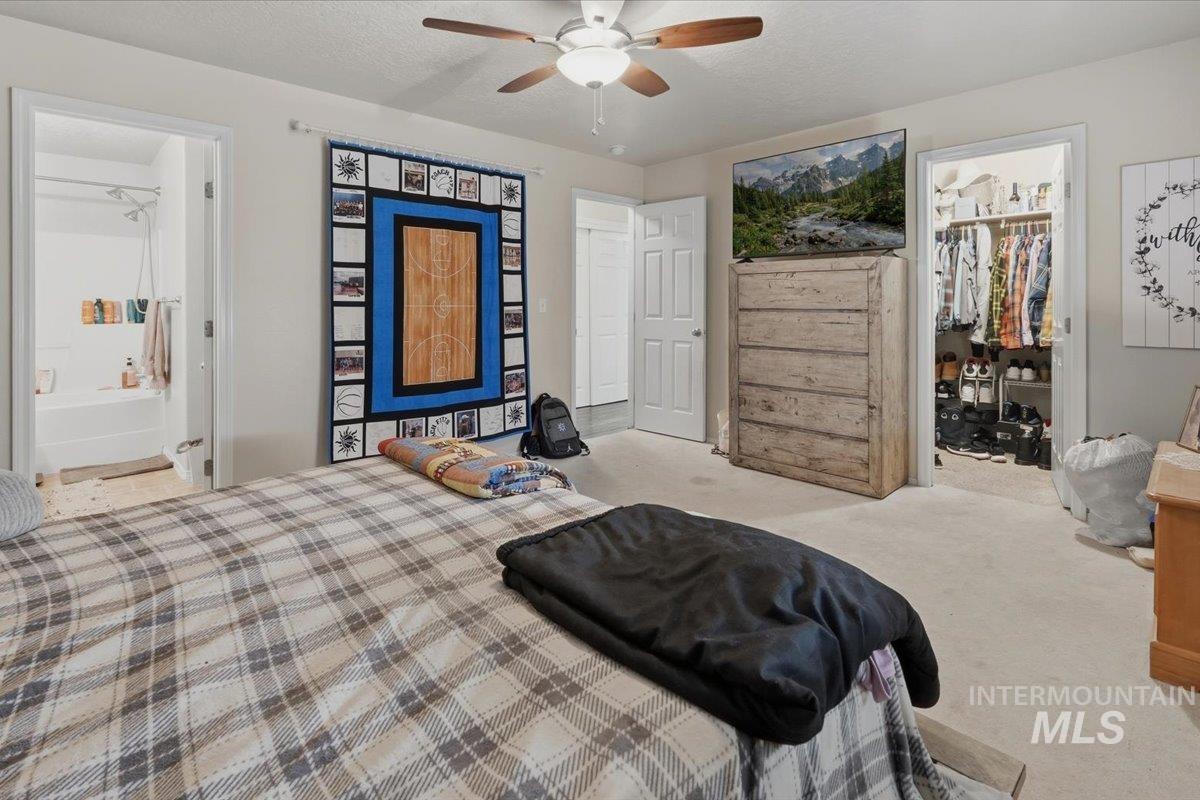 2714 Colfax Drive Caldwell, ID 83607 - Photo 14 of 40 Spacious room featuring light-colored carpet flooring, a ceiling fan with integrated lighting, and neutral wall tones