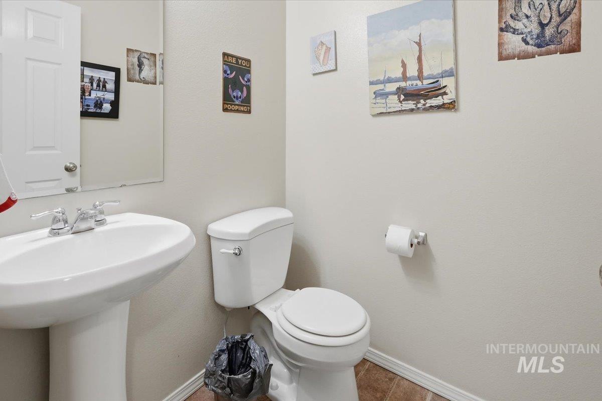 2714 Colfax Drive Caldwell, ID 83607 - Photo 15 of 40 Pedestal sink with chrome fixtures and a rectangular wall-mounted mirror