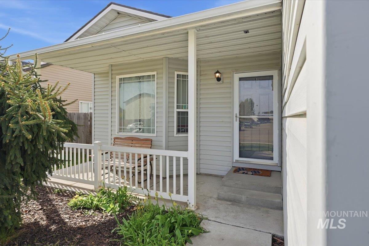 2714 Colfax Drive Caldwell, ID 83607 - Photo 2 of 40 Inviting covered front porch with white railings, featuring light-colored siding and a bright entry door