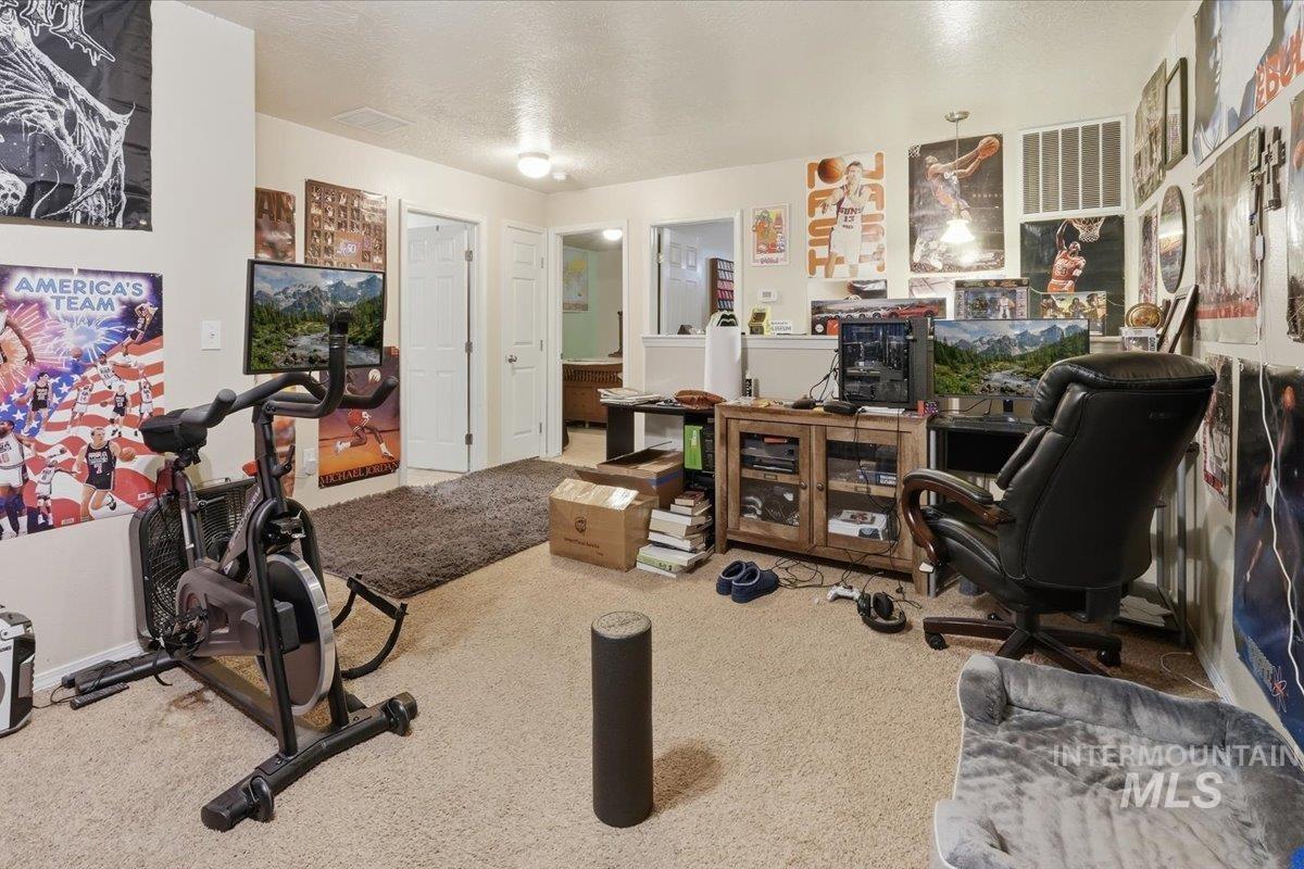 2714 Colfax Drive Caldwell, ID 83607 - Photo 23 of 40 Carpeted room with light-toned walls and multiple white interior doors