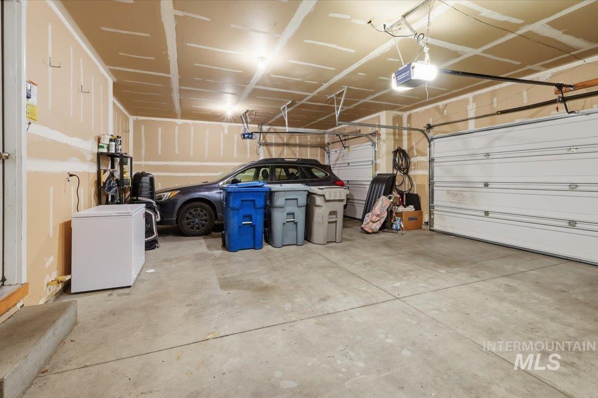 2714 Colfax Drive Caldwell, ID 83607 - Photo 26 of 40 Spacious two-car garage with concrete flooring and multiple overhead lighting fixtures