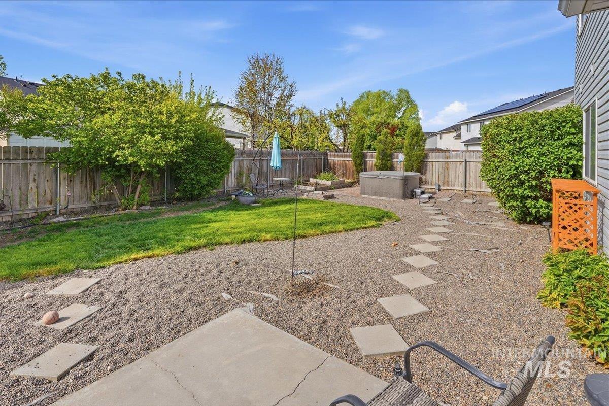 2714 Colfax Drive Caldwell, ID 83607 - Photo 27 of 40 Expansive backyard featuring a hot tub, a manicured lawn area, and mature perimeter landscaping