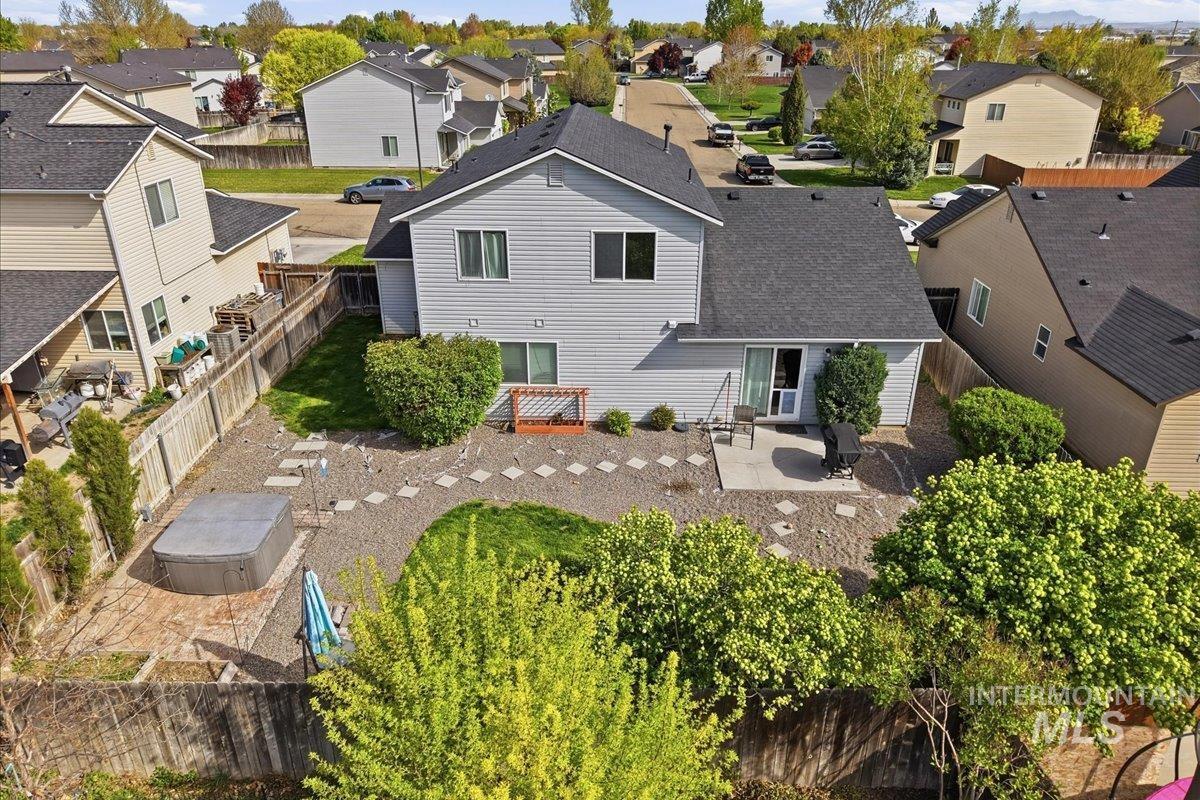2714 Colfax Drive Caldwell, ID 83607 - Photo 35 of 40 Rear exterior with light gray siding, dark shingle roof, and multiple windows