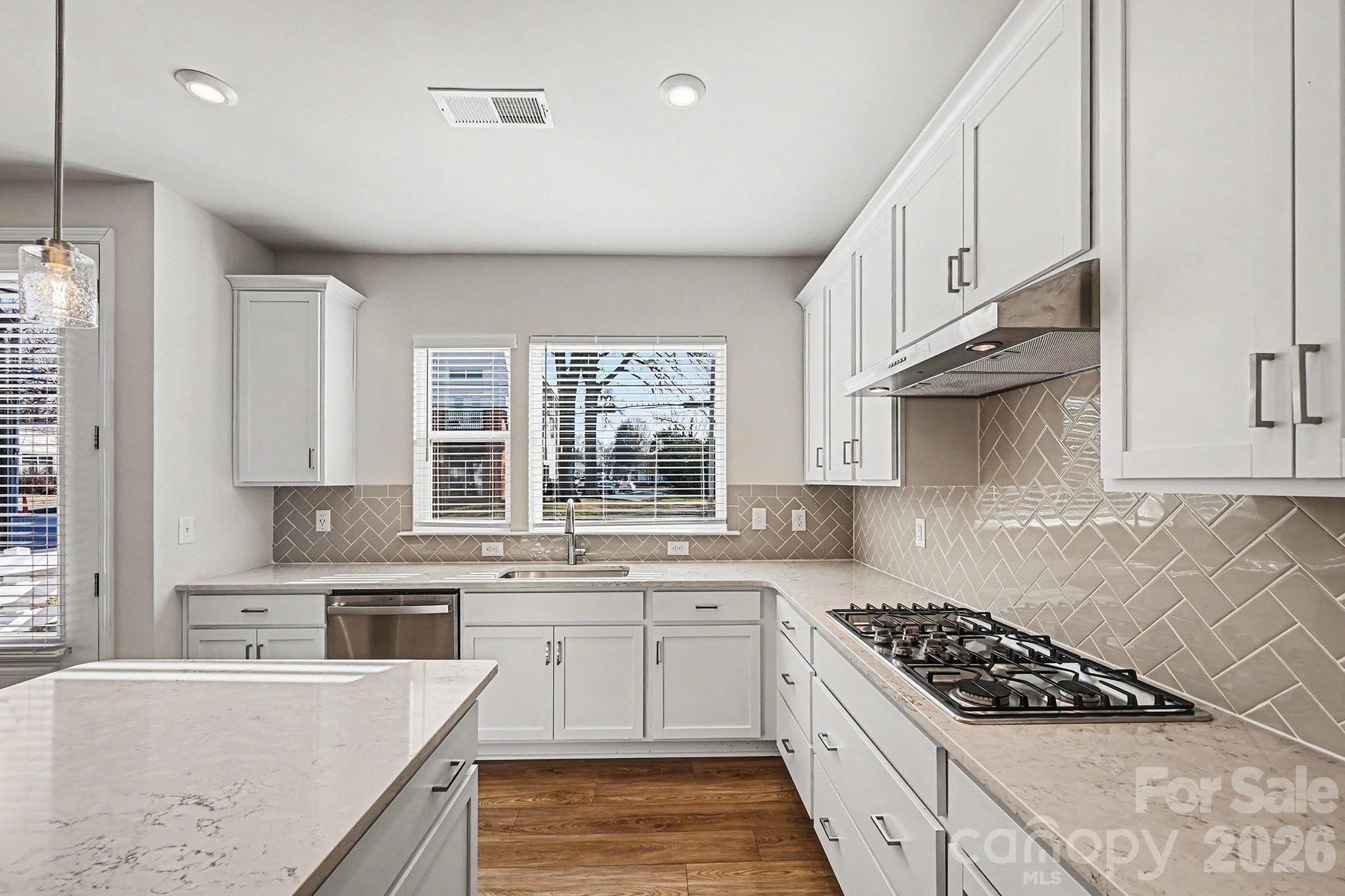 5451 Comiskey Alley Kannapolis, NC 28081 - Photo 11 of 27 a kitchen with stainless steel appliances granite countertop a sink stove and cabinets