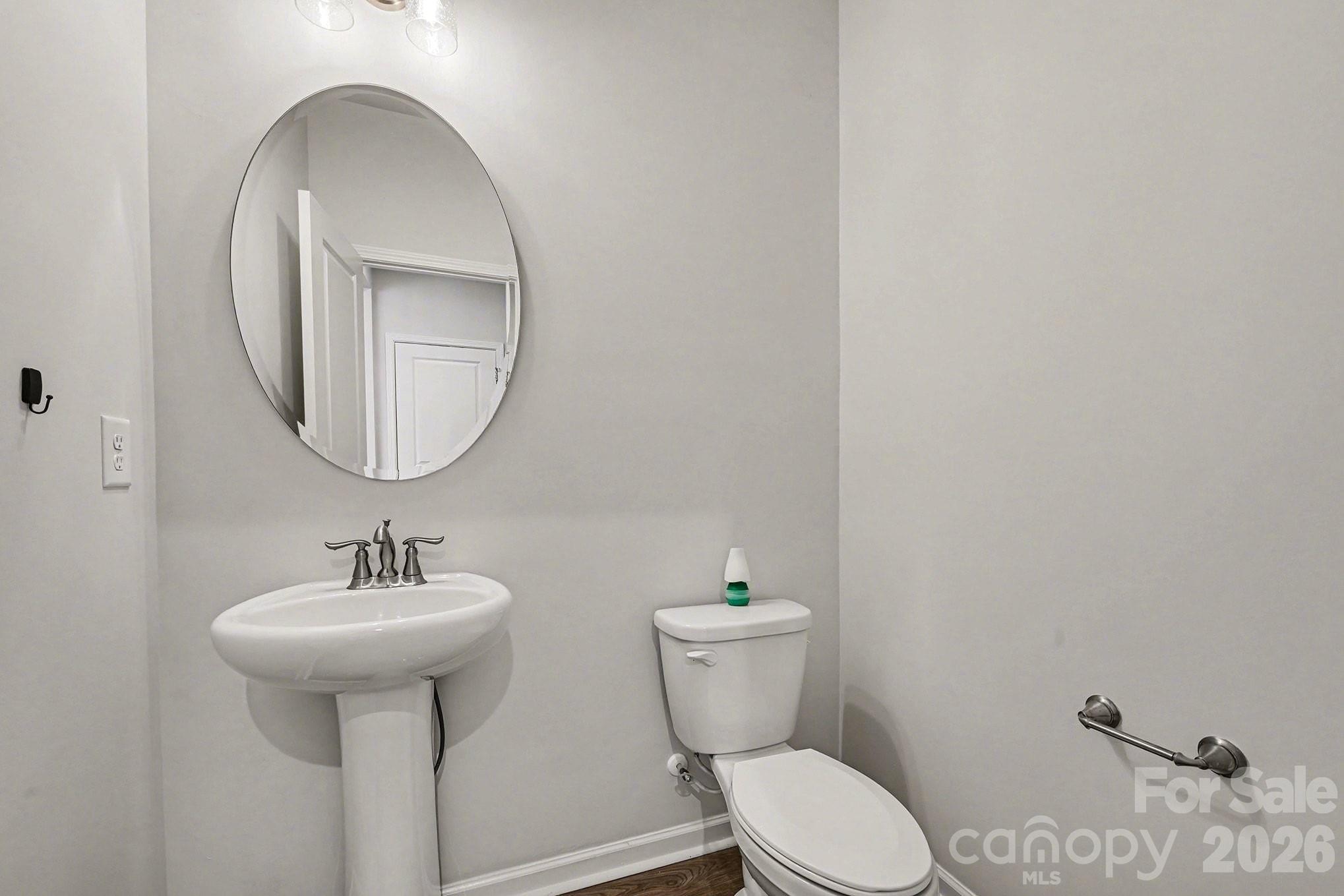 5451 Comiskey Alley Kannapolis, NC 28081 - Photo 13 of 27 a bathroom with a toilet sink and mirror