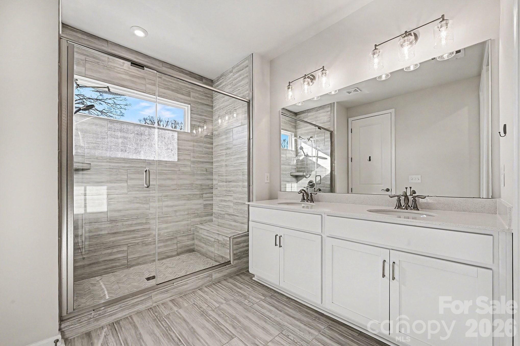 5451 Comiskey Alley Kannapolis, NC 28081 - Photo 18 of 27 a bathroom with a double vanity sink mirror and shower