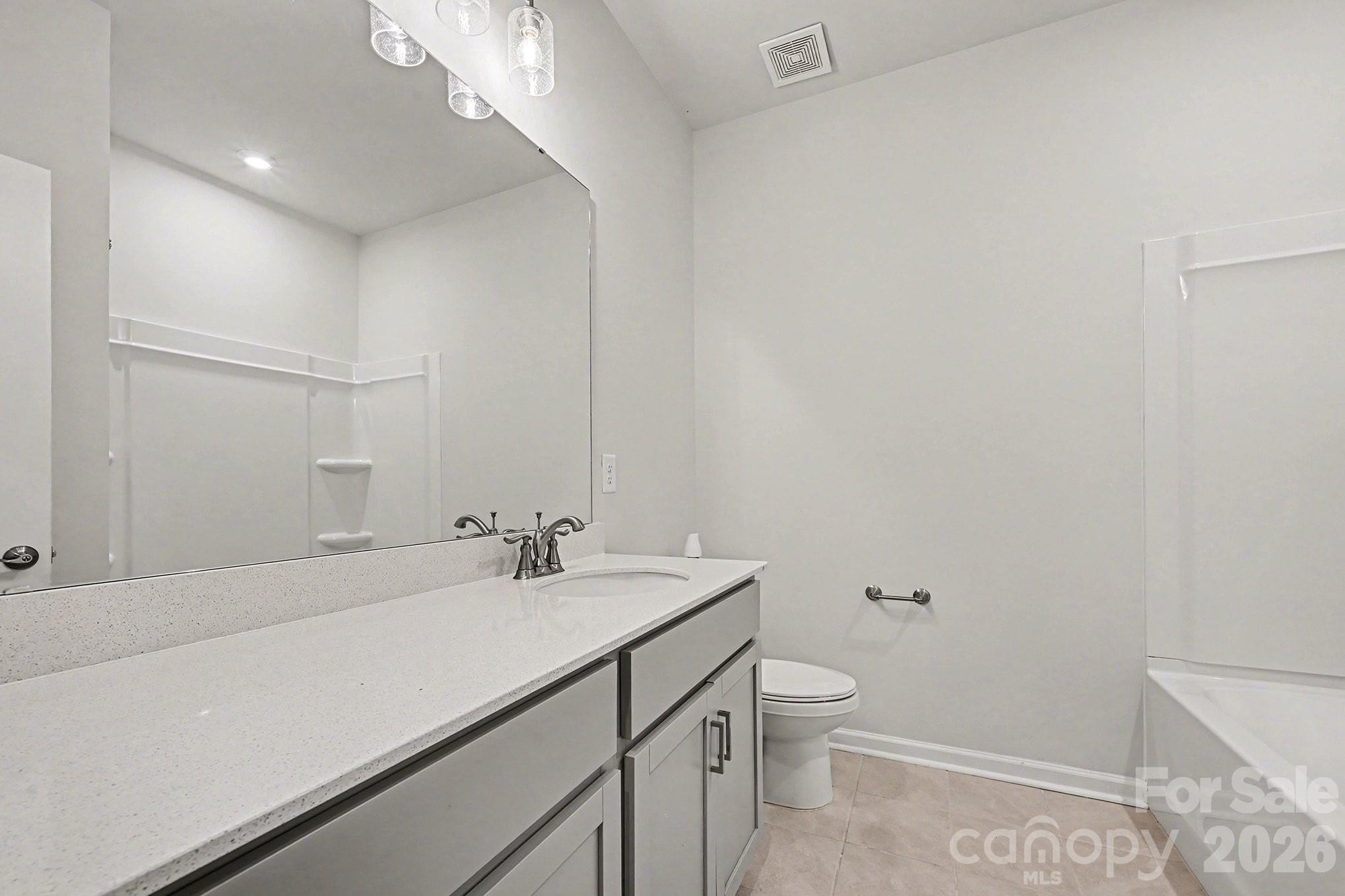 5451 Comiskey Alley Kannapolis, NC 28081 - Photo 22 of 27 a bathroom with a sink a toilet and a mirror