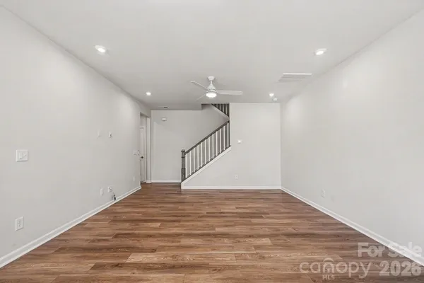 a view of an empty room with wooden floor