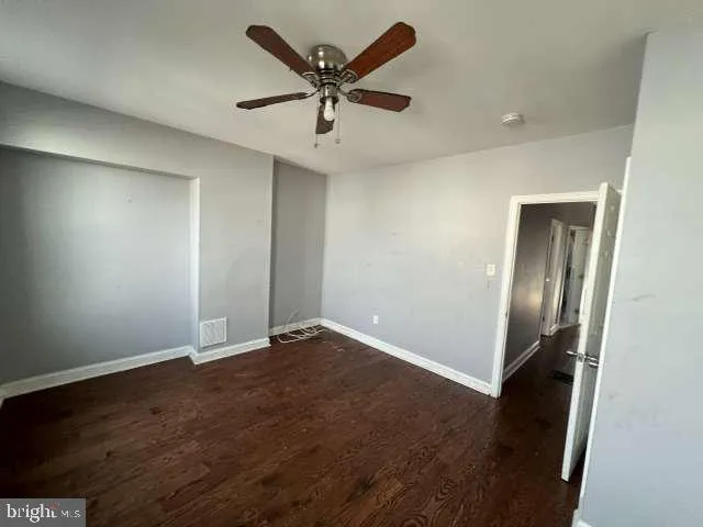 a bathroom with a sink a toilet a mirror and shower