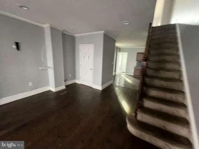 a kitchen with sink a microwave and cabinets