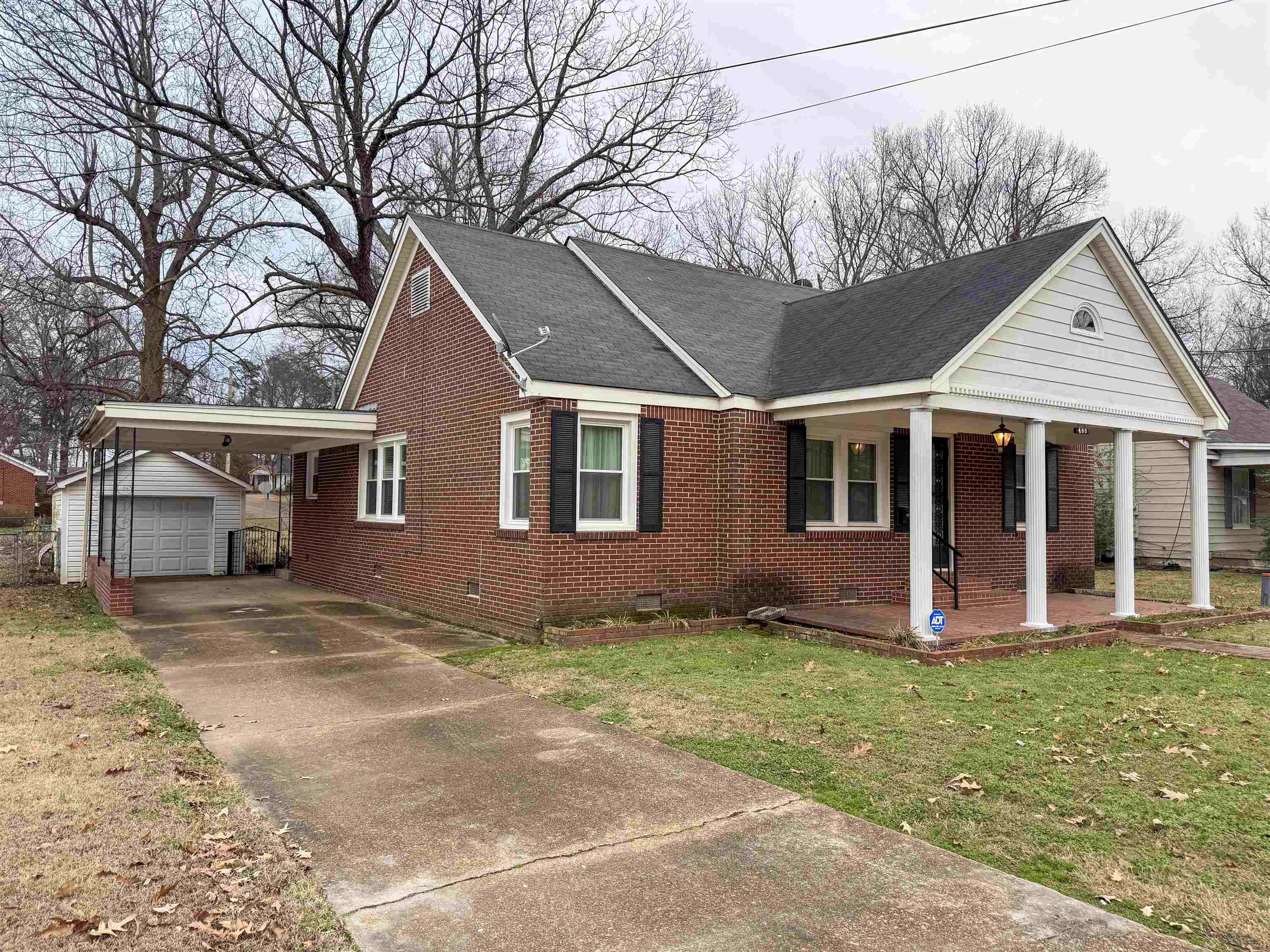 400 Park Street Covington, TN 38019 - Photo 3 of 24 a view of a yard in front of a house with large tree