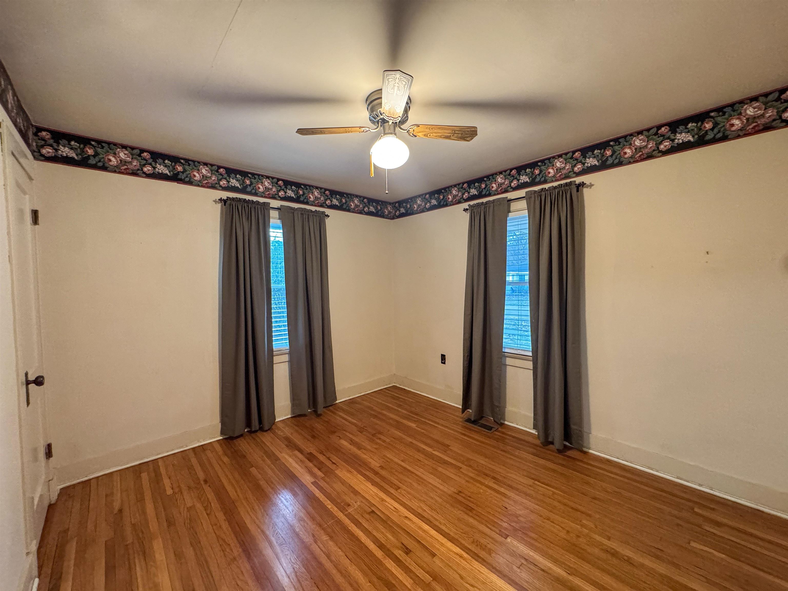 400 Park Street Covington, TN 38019 - Photo 7 of 24 a view of a room with wooden floor fan and windows