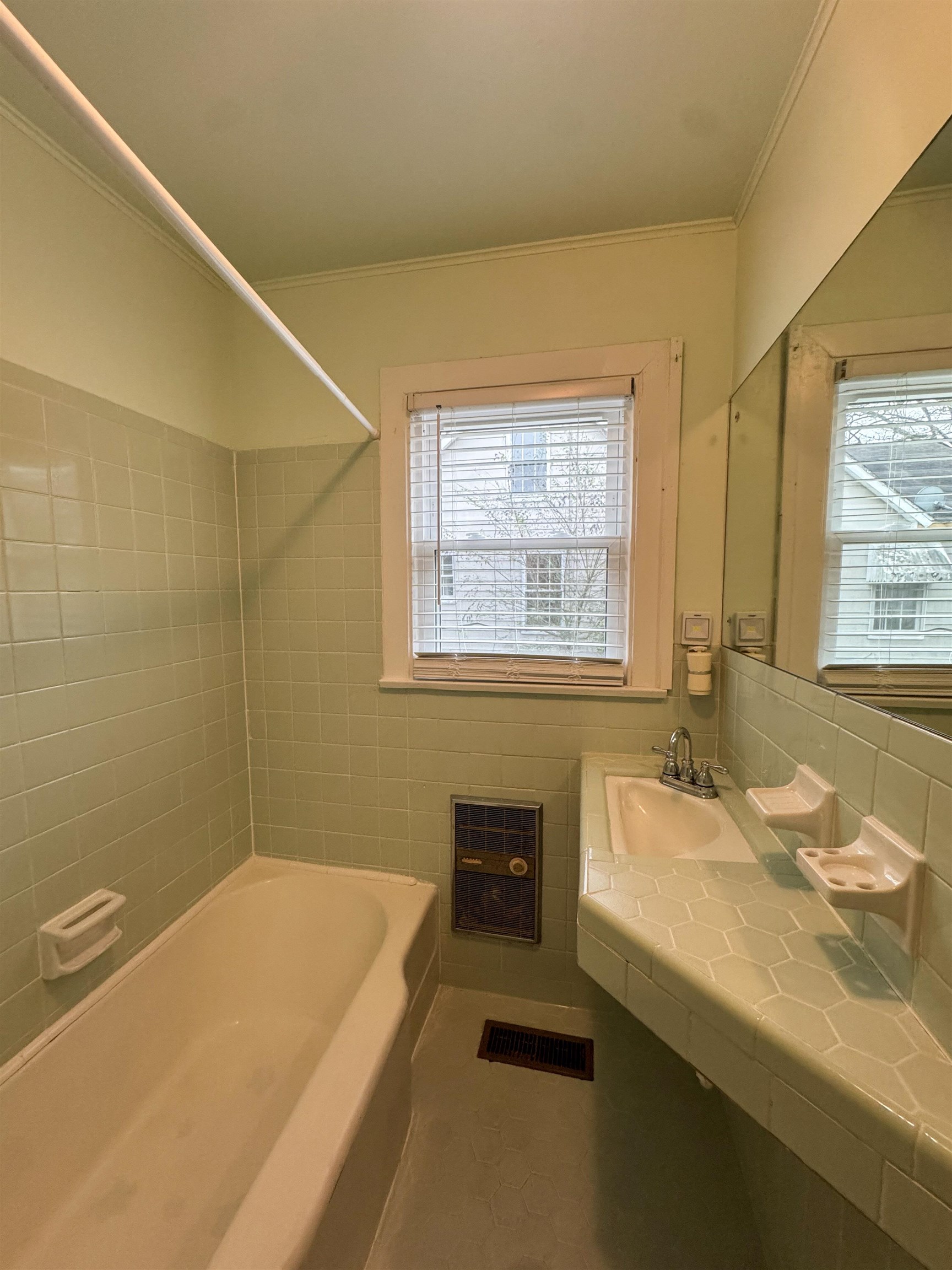 400 Park Street Covington, TN 38019 - Photo 8 of 24 a bathroom with a granite countertop sink a bathtub and a window