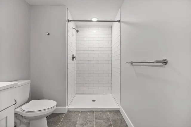 a bathroom with a shower and a toilet
