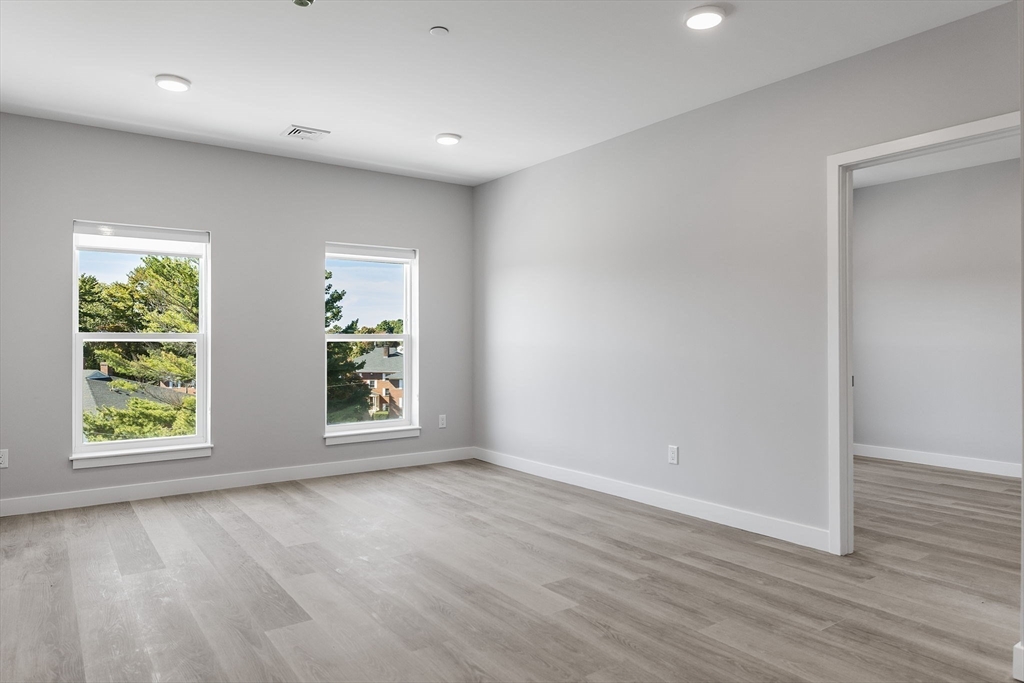 59 Mill Street, Unit 110 Woburn, MA 01801 - Photo 5 of 20 an empty room with windows