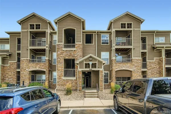 a front view of multiple houses with yard