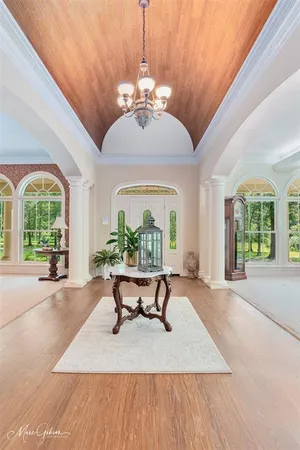 a view of a livingroom with furniture window and wooden floor
