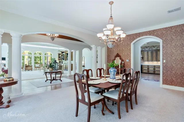 a view of a dining room with furniture and a chandelier