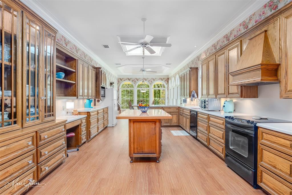 3669 Fountainbleau Road Keithville, LA 71047 - Photo 20 of 40 a large kitchen with stainless steel appliances granite countertop wooden floors and view of living room