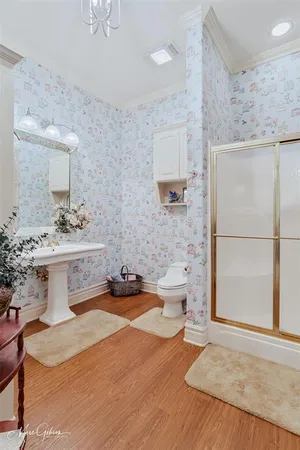 a bathroom with a sink a toilet and mirror