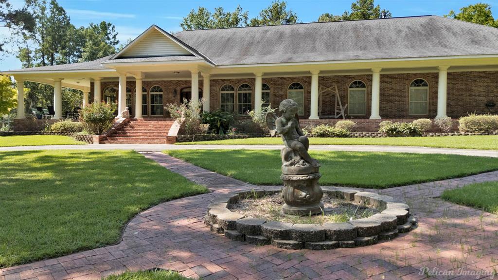 3669 Fountainbleau Road Keithville, LA 71047 - Photo 3 of 40 a front view of a house with a yard table and chairs