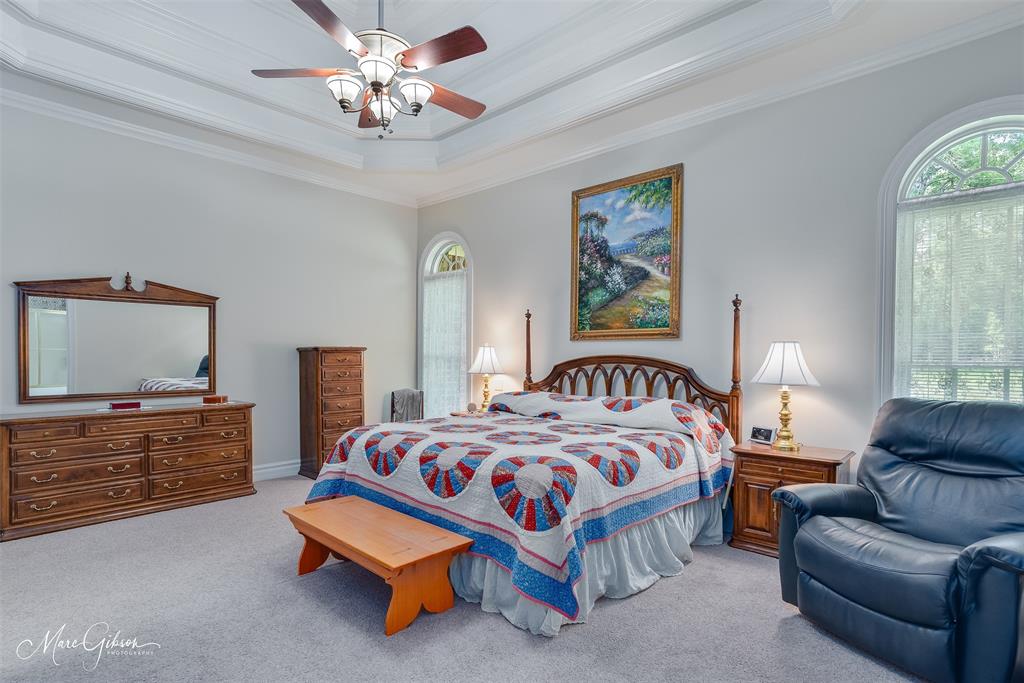 3669 Fountainbleau Road Keithville, LA 71047 - Photo 37 of 40 a bedroom with a bed and dresser with mirror