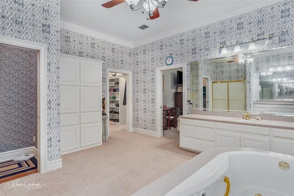 a large white kitchen with a large window