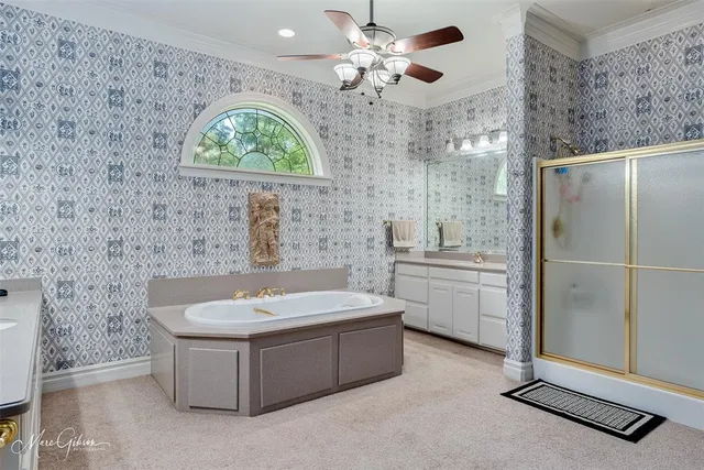 a bathroom with a double vanity sink a mirror and a bathtub