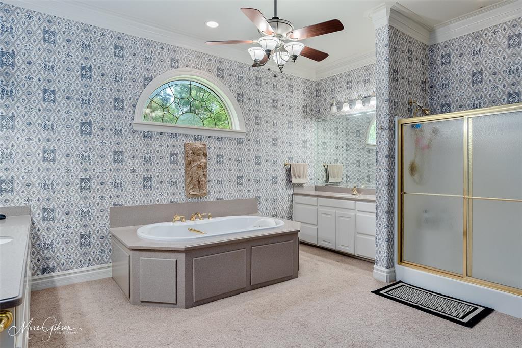 3669 Fountainbleau Road Keithville, LA 71047 - Photo 40 of 40 a bathroom with a double vanity sink a mirror and a bathtub